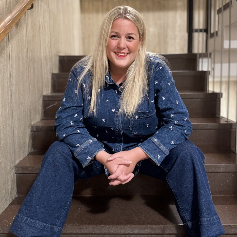 Matilda Olsson, co-founder of CIBoost, a Newground company, sitting in a stairwell looking into the camera