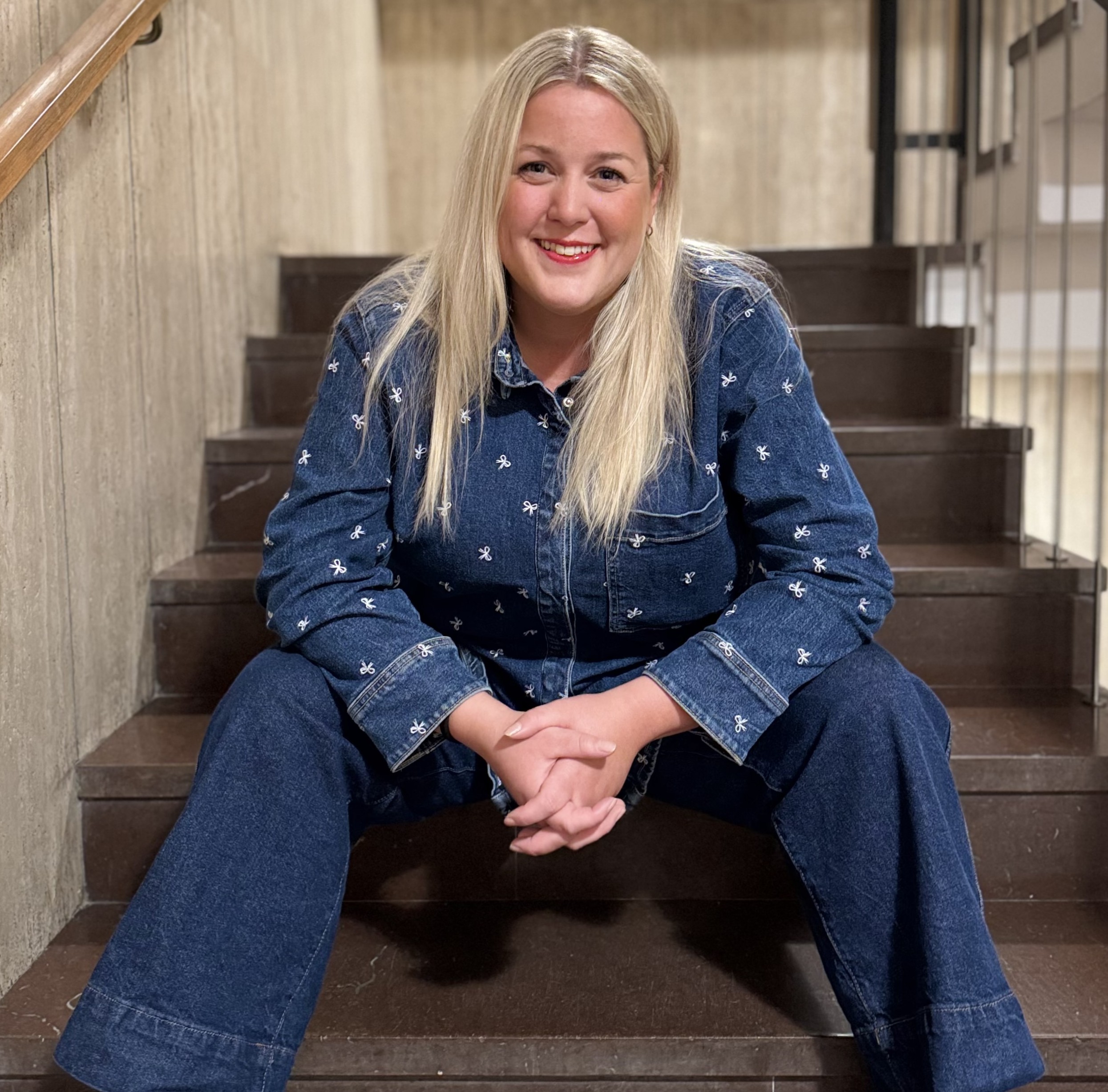 Matilda Olsson, co-founder of CIBoost, a Newground company, sitting in a stairwell looking into the camera